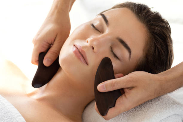 Woman during Chinese traditional massage - Gua Sha