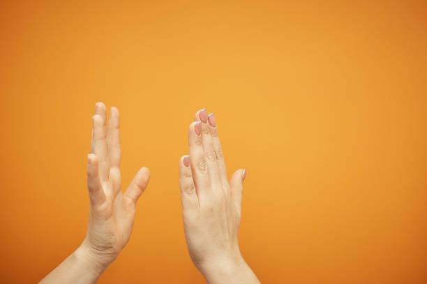 istock understanding and agreement, a handshake on an orange background 1078204484
