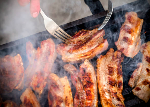 istock Barbeque outdoors arrangement with grilled pork meat bacon and smoke 1078206266