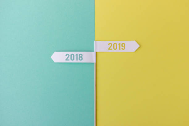Stick with flags showing 2018 and 2019 Minimalist composition of wood stick with flags showing towards the years 2018 and 2019 on colorful background new years 2019 stock pictures, royalty-free photos & images