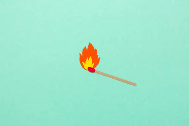 Photo of Paper cut match with flame illustration