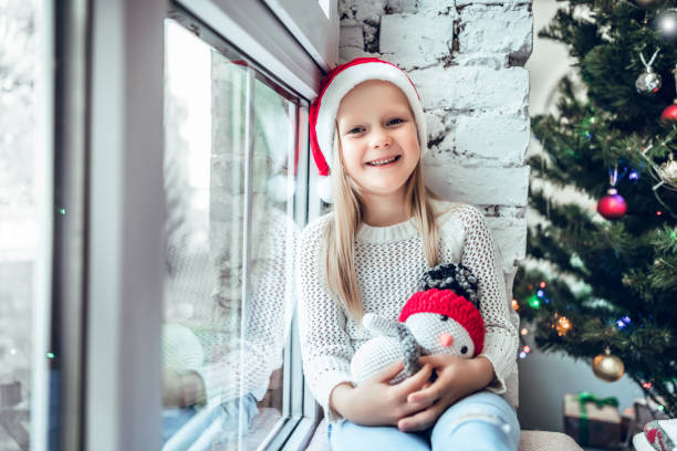 istock A little child sits on a window sill. 1078215770