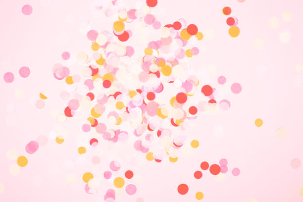 istock Colorful confetti on coral background. 1078223502