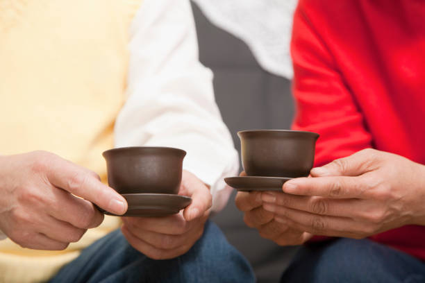 istock Pair of hands holding tea cups in China 1078229446
