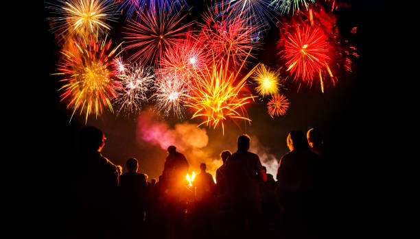 istock People standing in front of colorful Firework 1078232262