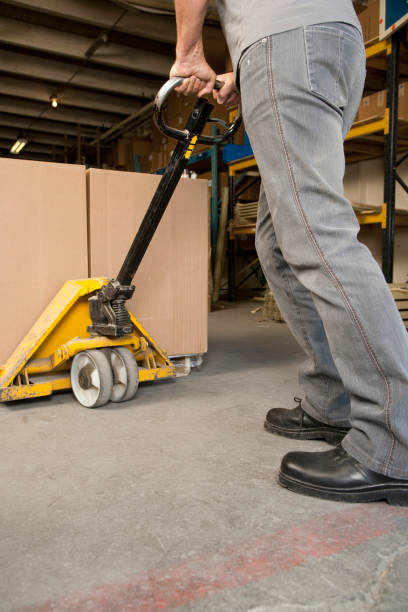 istock Man pushing a skid in warehouse 1078234594