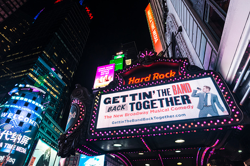 New York City, USA - July 30, 2018: Hard Rock on Times Square at night with large advertising screens in Manhattan in New York City, USA