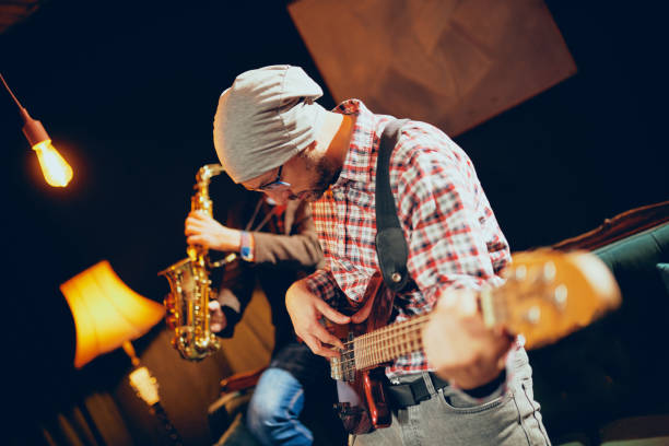 istock Young Caucasian man with hat on head playing bass guitar. 1078243502