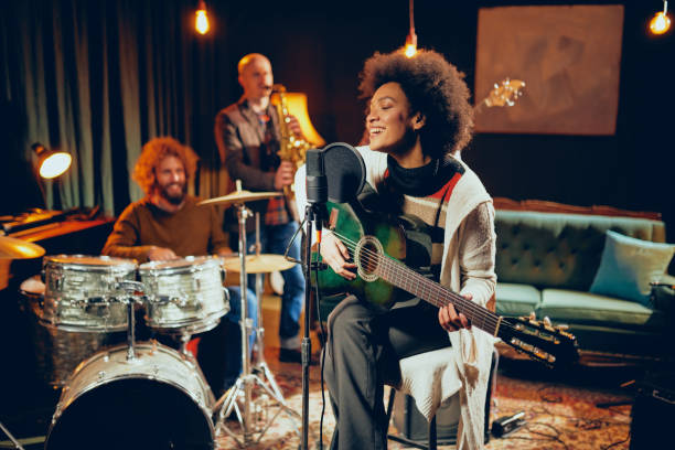 istock Mixed race woman singing and playing guitar. 1078244022