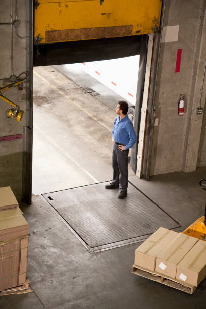 istock Man standing at warehouse door to receive shipment 1078245914