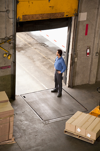 Man standing at warehouse door to receive shipment