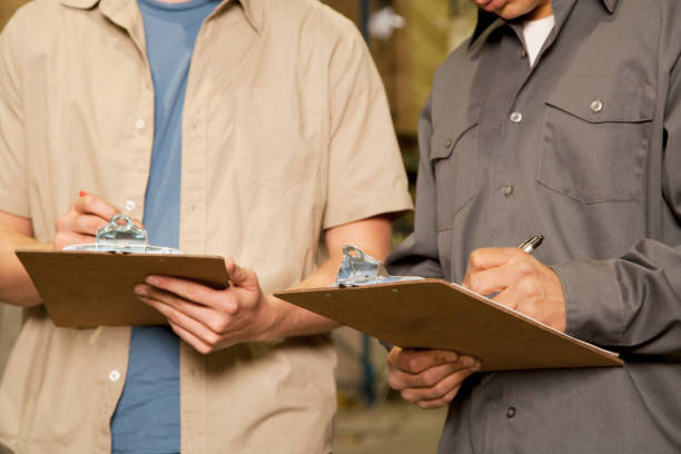 istock Colleagues writing on clipboards in warehouse 1078246006