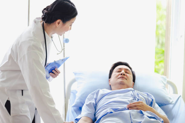 istock Doctor women standing talking old patient men on bed 1078252362
