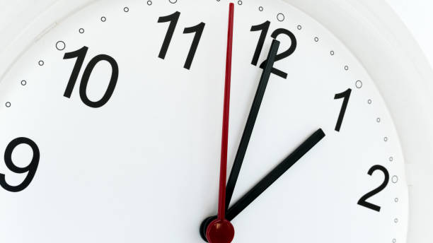 istock Closeup clock ticking showing twelve hours 1078256022