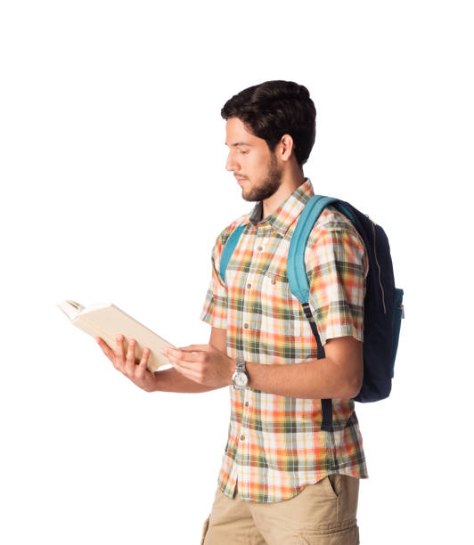 istock Latin male student standing and reading book 1078256572