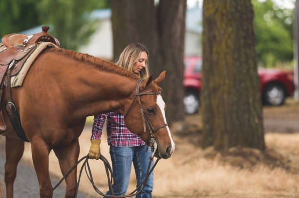 istock Woman walking her horse outside 1078258242