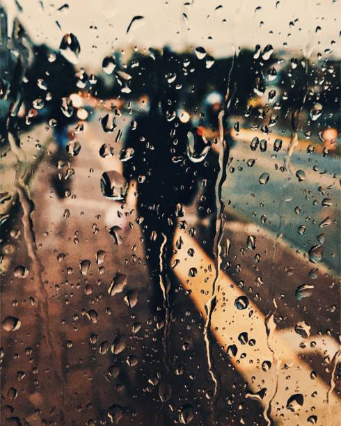 istock Raindrops on glass and city street 1078258526