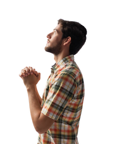 istock Side view of young man praying 1078260450