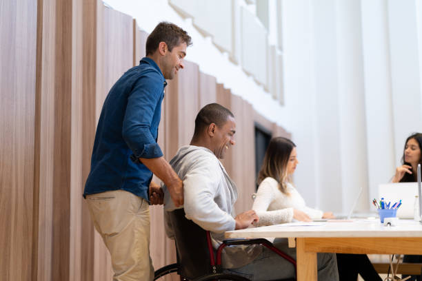 istock Disabled man helping by coworker at workplace 1078262720