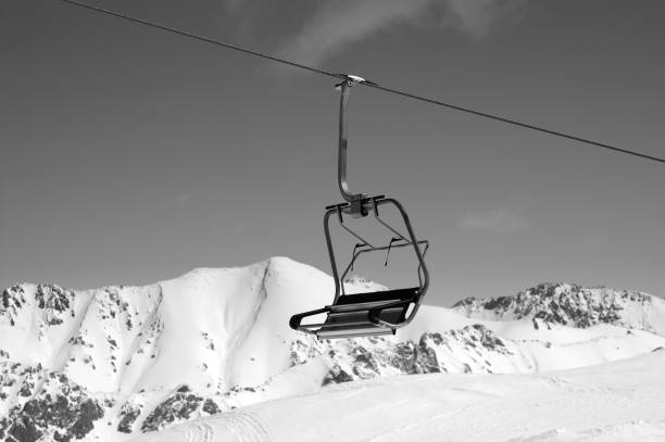 istock Black and white view on ski-lift and sunlight mountains 1078265268