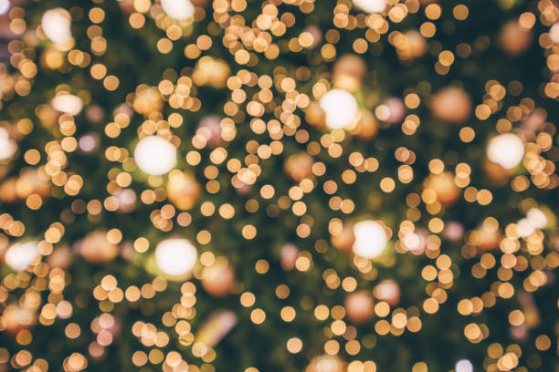 istock Abstract christmas holiday with festive gold bokeh light on tree blurred background 1078265388