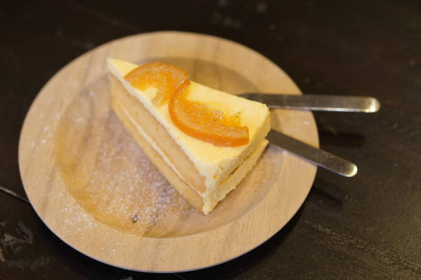 istock slice orange​ and cake serve on wood dish 1078277234