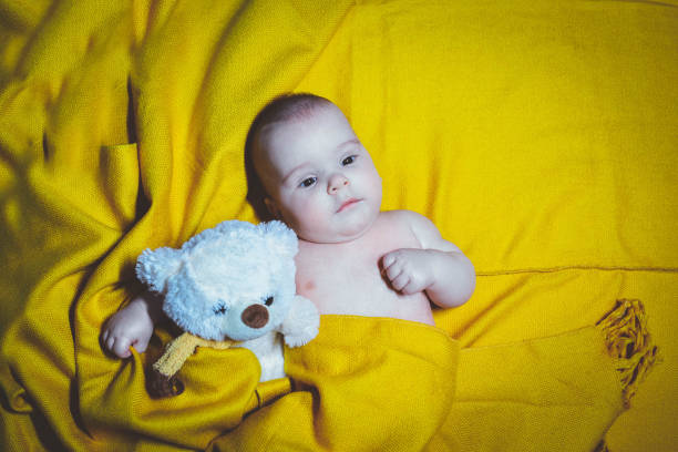 istock Cute baby in bed smiling and looking around 1078277336