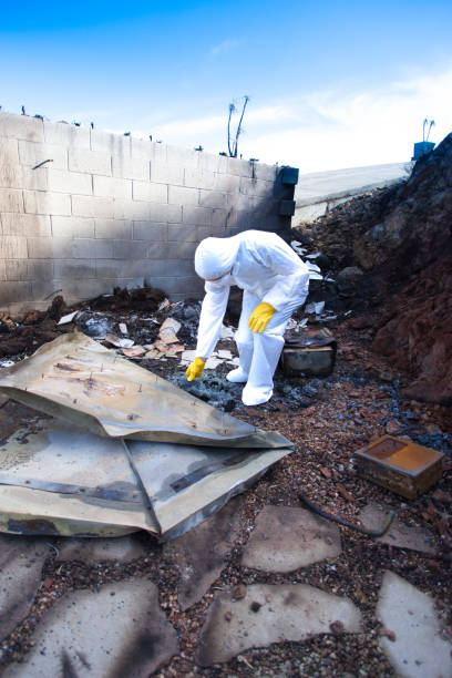 istock Man in Hazmat Suit Picking Through Wildfire Rubble 1078283830