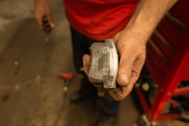 Mechanic Holding Automobile Bad Brake Pads