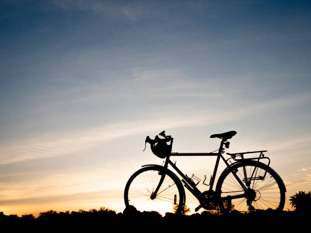 istock silhouette bike packing with the beautiful view 1078290978