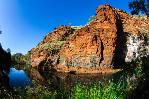 istock Ancient Aboriginal birthing pool. Wittenoom Gorge. This clear, crystal water oasis is where the aboriginals used to go to give birth 1078299180