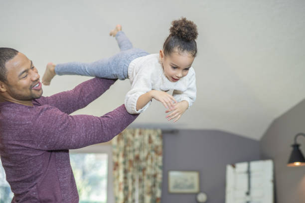istock Dad flying his daughter through the air 1078303324