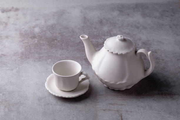 istock Teapot creamer, Cup and saucer on Cement Board 1078320102