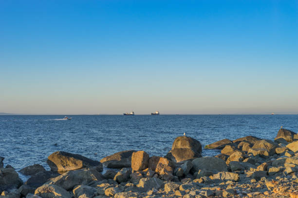istock Seascape with beautiful sunset and ships on the horizon. 1078320244