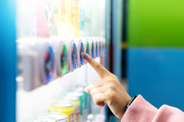 sell, technology and consumption concept, Woman buying with a vending machine sell, technology and consumption concept, Woman buying with a vending machine vending machine photos stock pictures, royalty-free photos & images