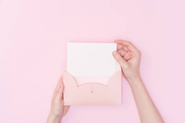 istock female hand hold letter 1078329350