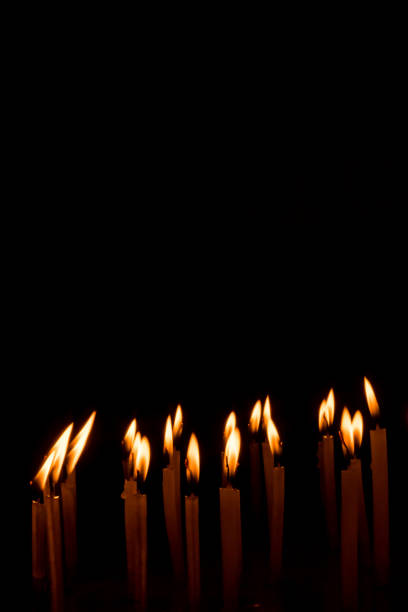 istock Many christmas candles burning at night on the black background. 1078356028