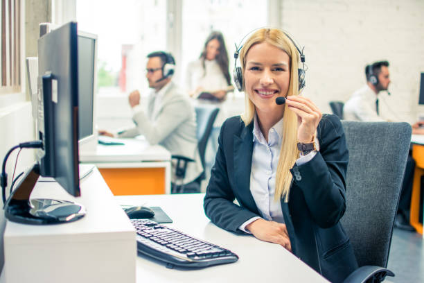 istock Smiling young woman with headset working in call center. 1078356202