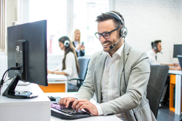 istock Smiling young male customer support executive in call centre 1078356206