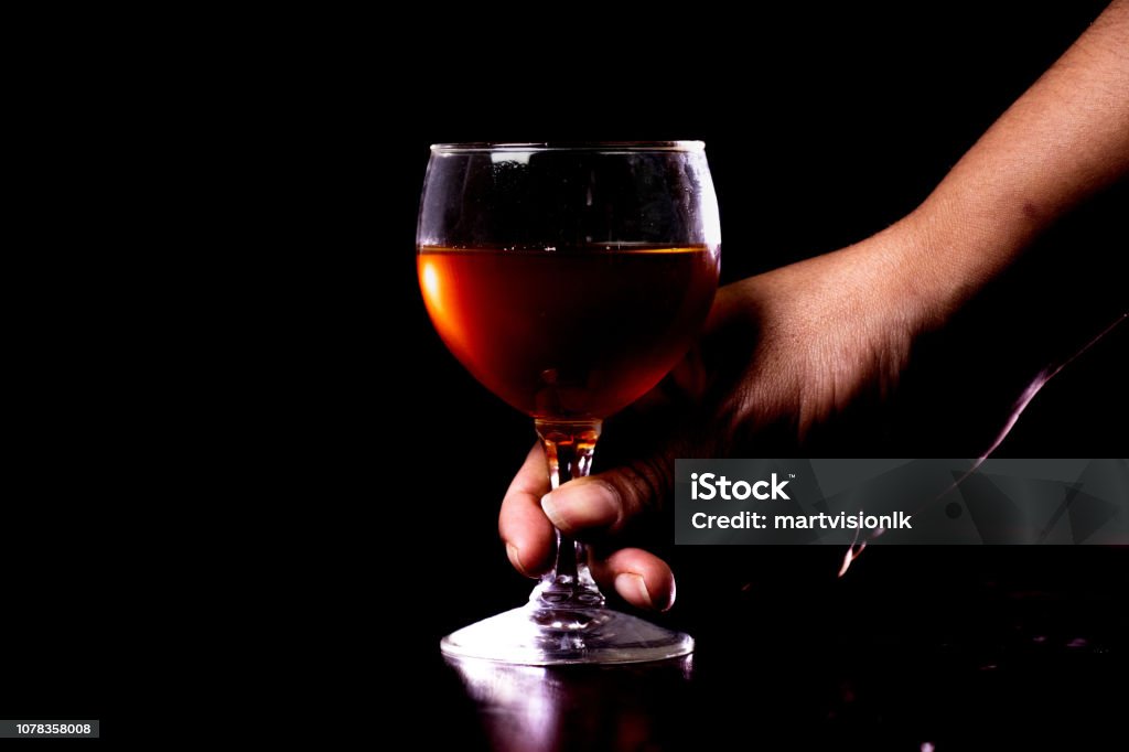 Hand holding a glass of wine Adult Stock Photo