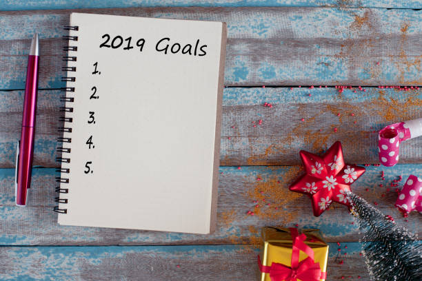 istock 2019 goals list with notebook and pen on rustic blue wooden table 1078371844