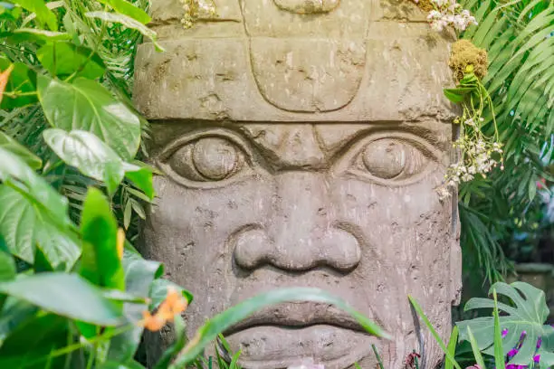 Photo of Close up of religious stone statue in tropical forest. Mayan antique  heritage