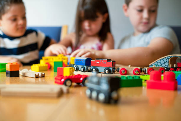 istock Siblings playing with blocks, trains and cars 1078379422