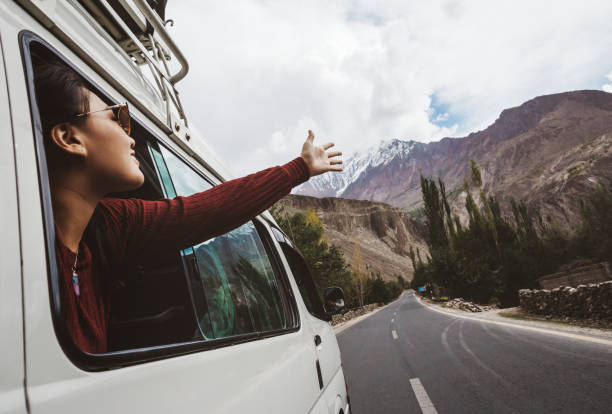 Woman enjoying the cool breeze from the car window Woman enjoying the cool breeze from the car window 4x4 photos stock pictures, royalty-free photos & images