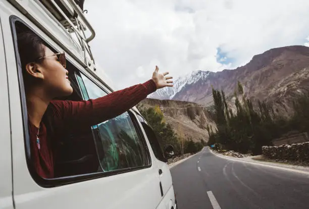 Photo of Woman enjoying the cool breeze from the car window