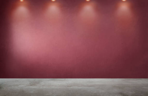 istock Red wall with a row of spotlights in an empty room 1078382766