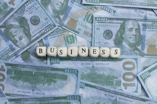 The business word on wood brick  background banknote.