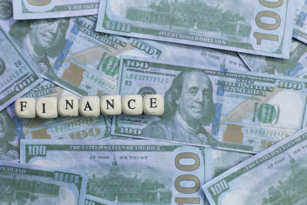 istock Finance word on wood brick  background banknote. 1078383332