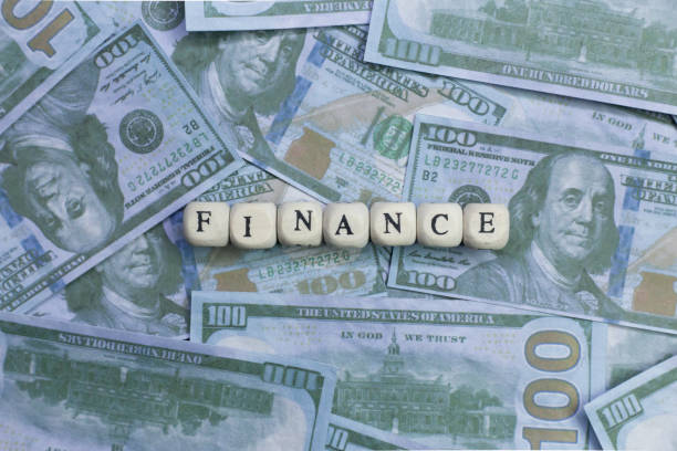 istock Finance word on wood brick  background banknote. 1078384478