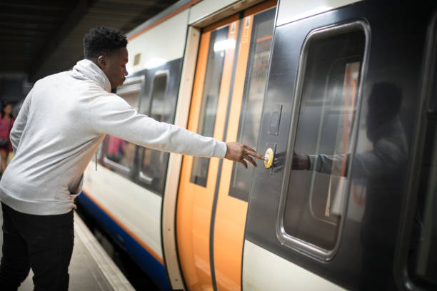 istock Man pushing a button to open the train doors 1078385016